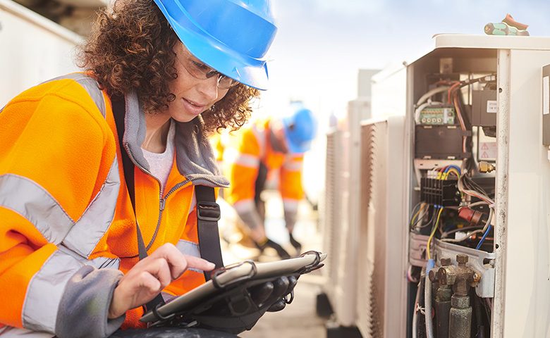 female electrician with aircon unit