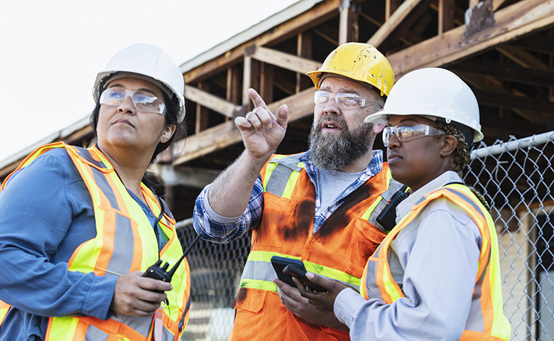 Workers on a construction site trying to figure something out